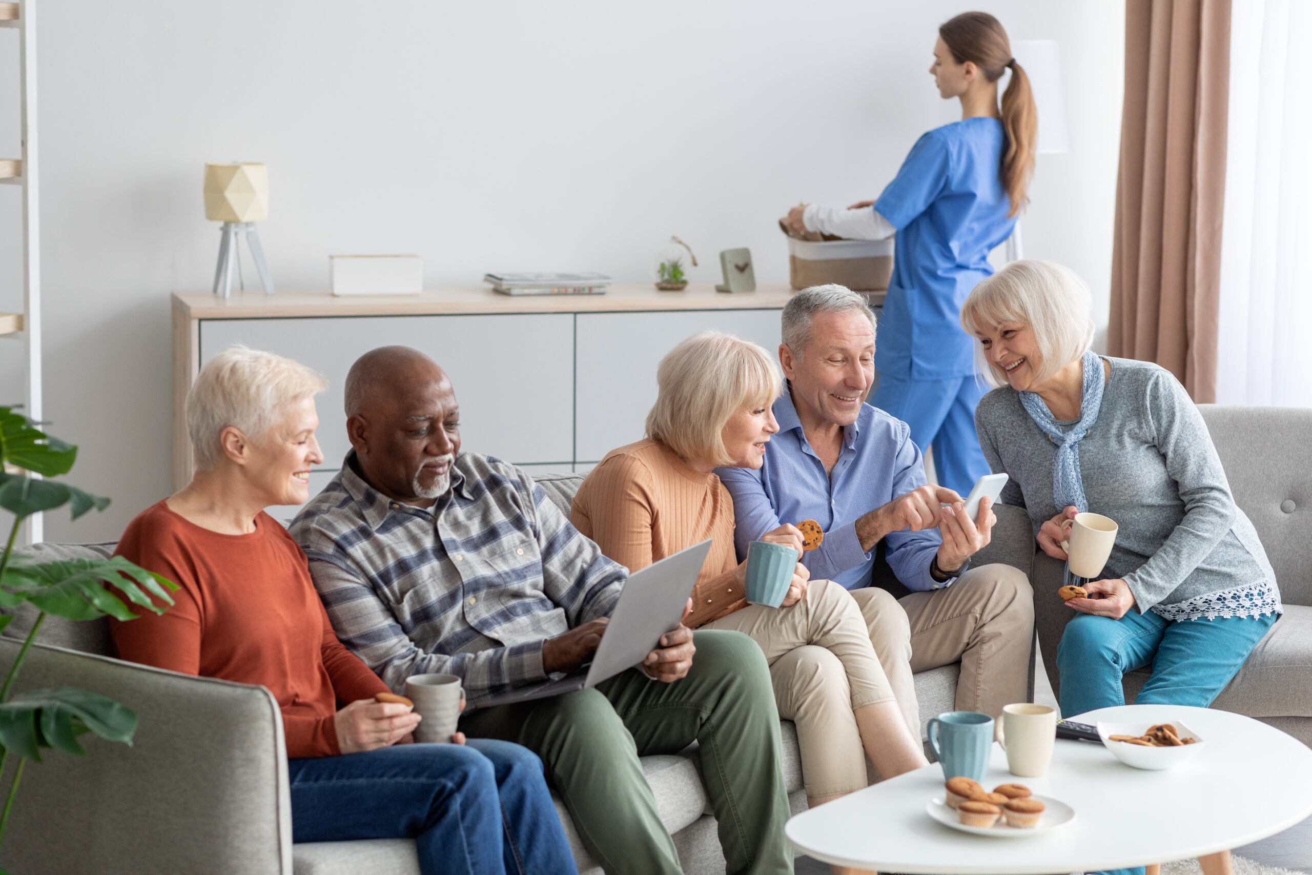 Happy elderly men and women enjoying time at nursing home